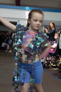 Young Model Showcases Unique Garment Made By Carmel Fashion & Textile Students At Bazaar Exhibition
